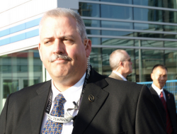 Is this guy United States Secret Service? Check out the lanyard around his neck. (Click picture to enlarge)
